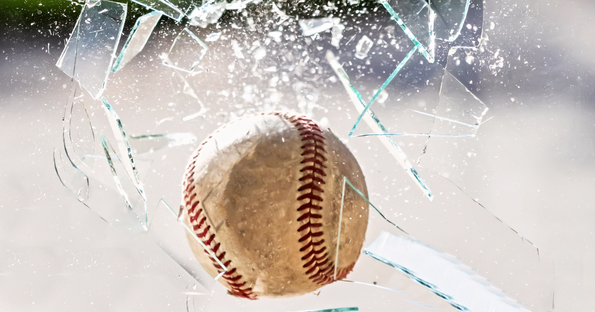 Baseball breaking rental property window.