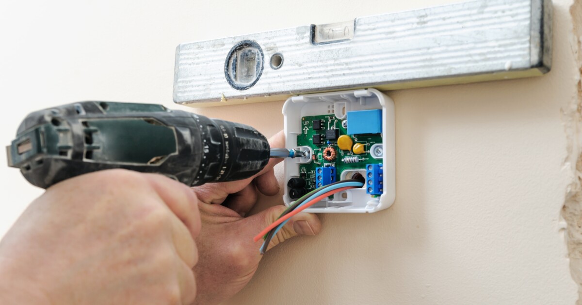 Landlord installing Smart Thermostat as part of sustainable property upgrades