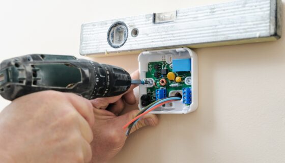 Landlord installing Smart Thermostat as part of sustainable property upgrades